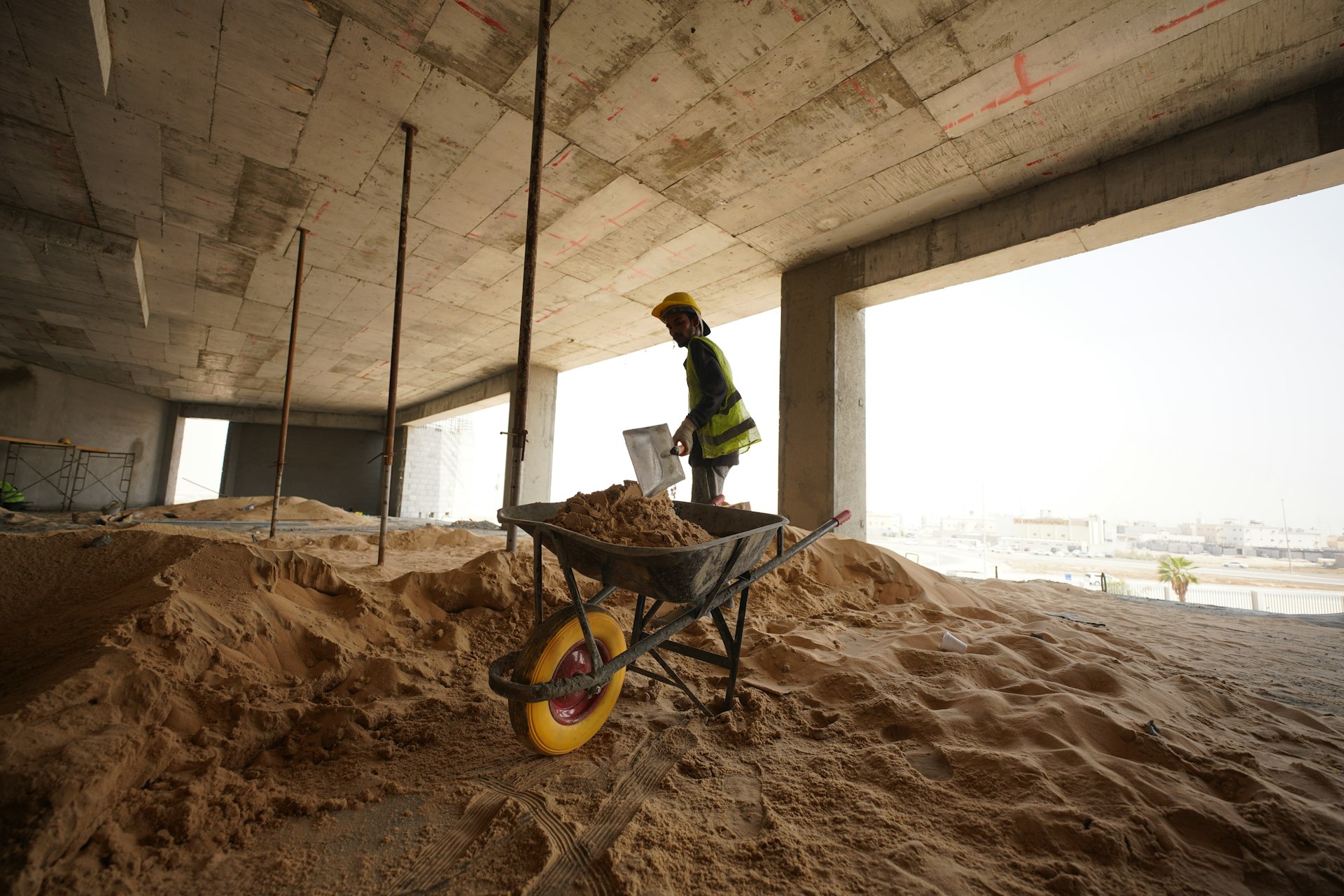 a construction worker standing in a pile of sand